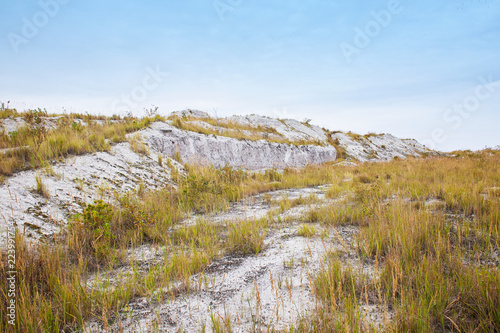 Landscape with white mountains and hills. Amazing abandoned desert view. Phosphogypsum stack of chemical production wastes. Autumn view photo