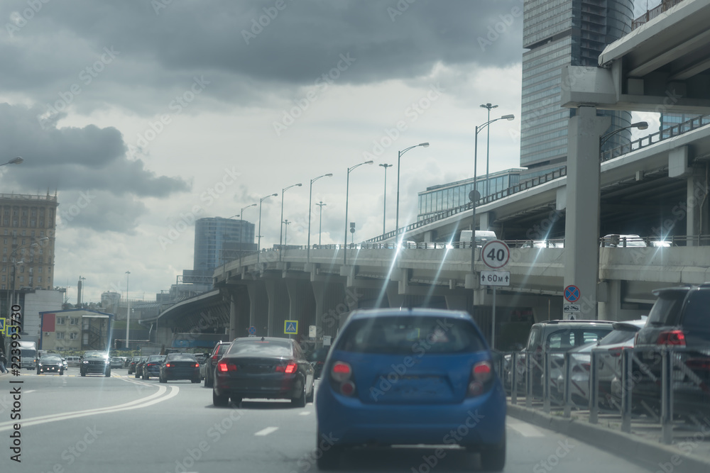 New Riga highway. Elevated roads on cloudy day. City traffic with a lot of cars.