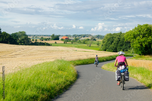 Groupp of  cycle tourist on the scenic countryside road in Denmark - island Mon.