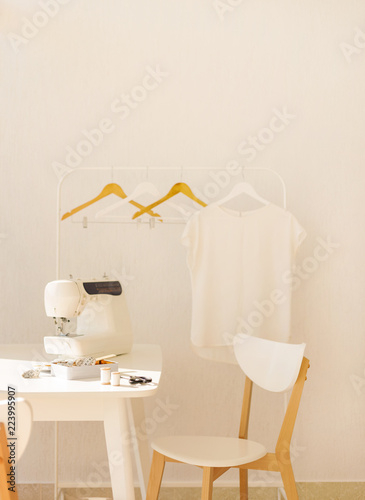 Workplace for sewing and needlework in a bright room with white furniture.