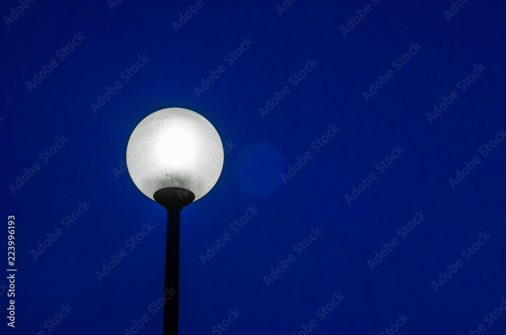 Street lamp on the pillar, shines at night Street lamp on the pillar, shines at night