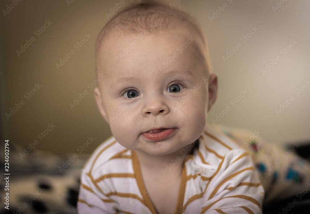 Portrait of a expressive happy baby, holds head up. baby development concept photo, lifestyle Portrait of a expressive happy baby, holds head up. baby development concept photo, lifestyle