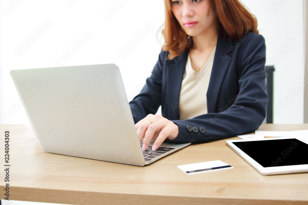 Selective focus on hands of attractive Asian business woman working with laptop in office. Selective focus on hands of attractive Asian business woman working with laptop in office.