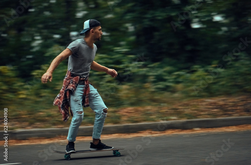 Young people skateboarding on road.