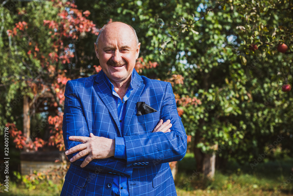 Mature European or American man with a good mood, outdoor portrait. The concept of life after 50-60 years. Positive emotions in senior life. Inspirations in everyday life Mature European or American man with a good mood, outdoor portrait. The concept of life after 50-60 years. Positive emotions in senior life. Inspirations in everyday life