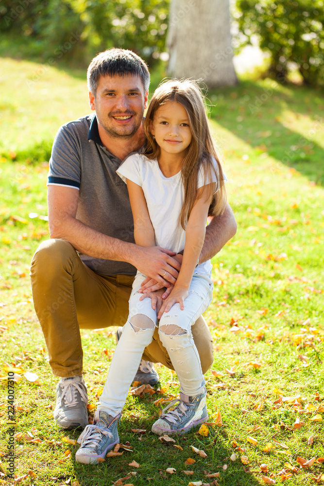 Fototapeta premium Portrait of a young father with his daughter