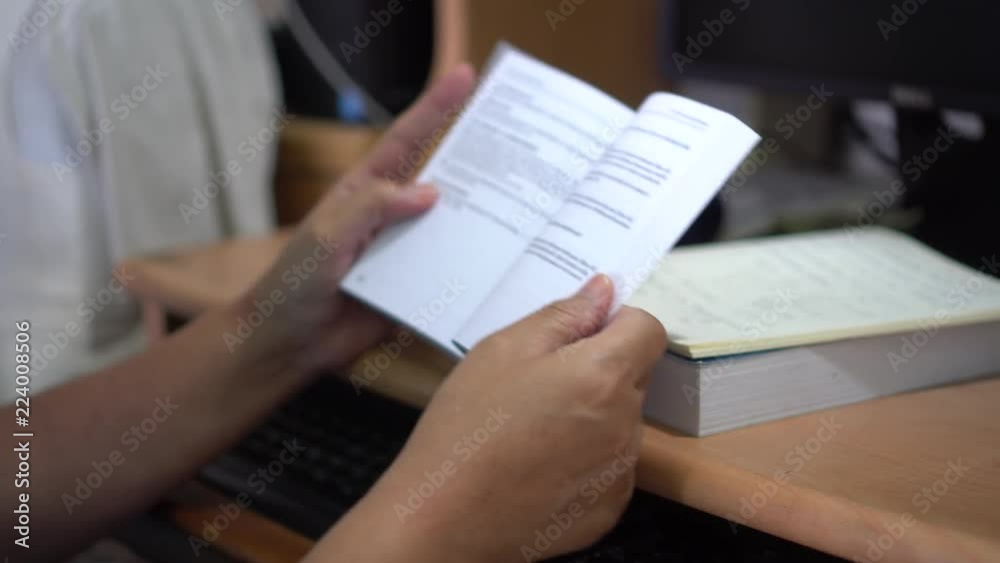Education for reading book and Learning Studying concept : Asian student read a textbook on desk in library for learning by self at university or college Education for reading book and Learning Studying concept : Asian student read a textbook on desk in library for learning by self at university or college