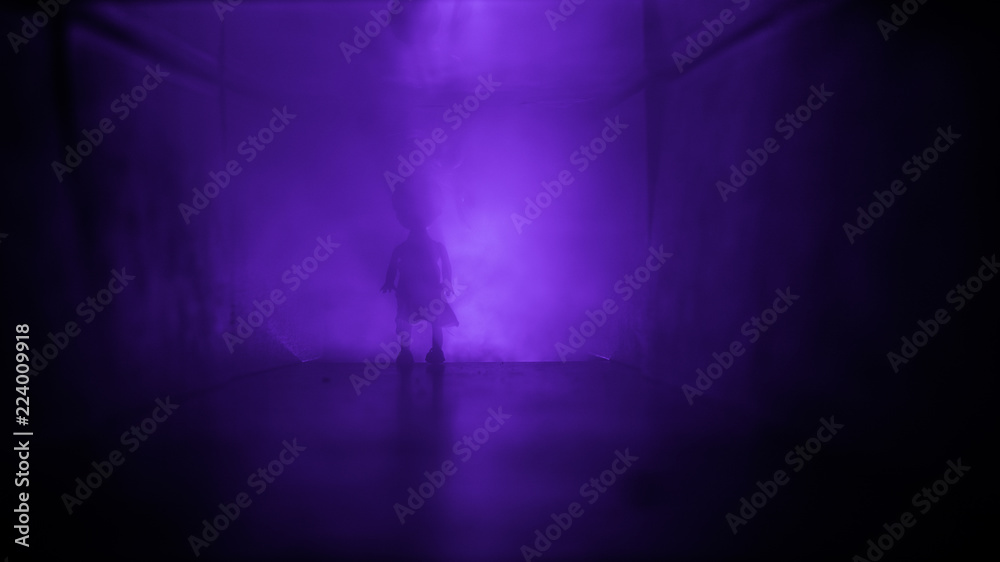 Creepy silhouette in the dark abandoned building. Horror about maniac concept or Dark corridor with cabinet doors and lights with silhouette of spooky horror person