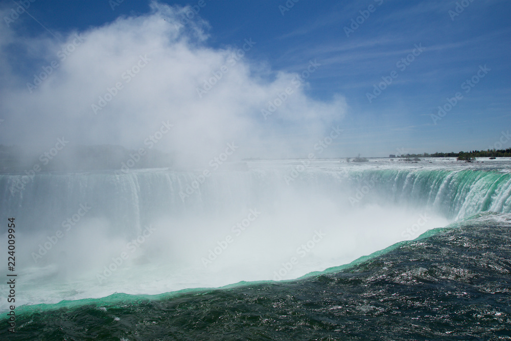 NIAGARA FALLS, ONTARIO, CANADA - MAY 21st 2018: Edge of the Horseshoe Falls as viewed from Table Rock in Queen Victoria Park in Niagara Falls NIAGARA FALLS, ONTARIO, CANADA - MAY 21st 2018: Edge of the Horseshoe Falls as viewed from Table Rock in Queen Victoria Park in Niagara Falls