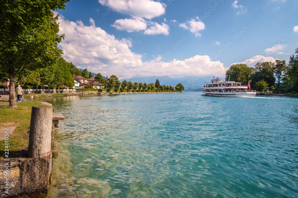 Boat is sailing on the Aare towards Lake Thun (Switzerland). The Aare or Aar is a tributary of the High Rhine and the longest river that both rises and ends completely within Switzerland.