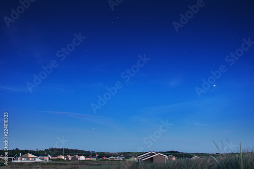 Night view of a small danish village with cute holoday beach houses at the north sea.  Lønstrup in North Jutland in Denmark, Skagerrak, North Sea photo