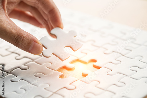 Photography Hand put the last piece of jigsaw puzzle to complete the mission, Business solut