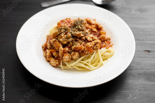 Spaghetti on black wooden background