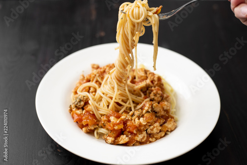 Spaghetti on black wooden background