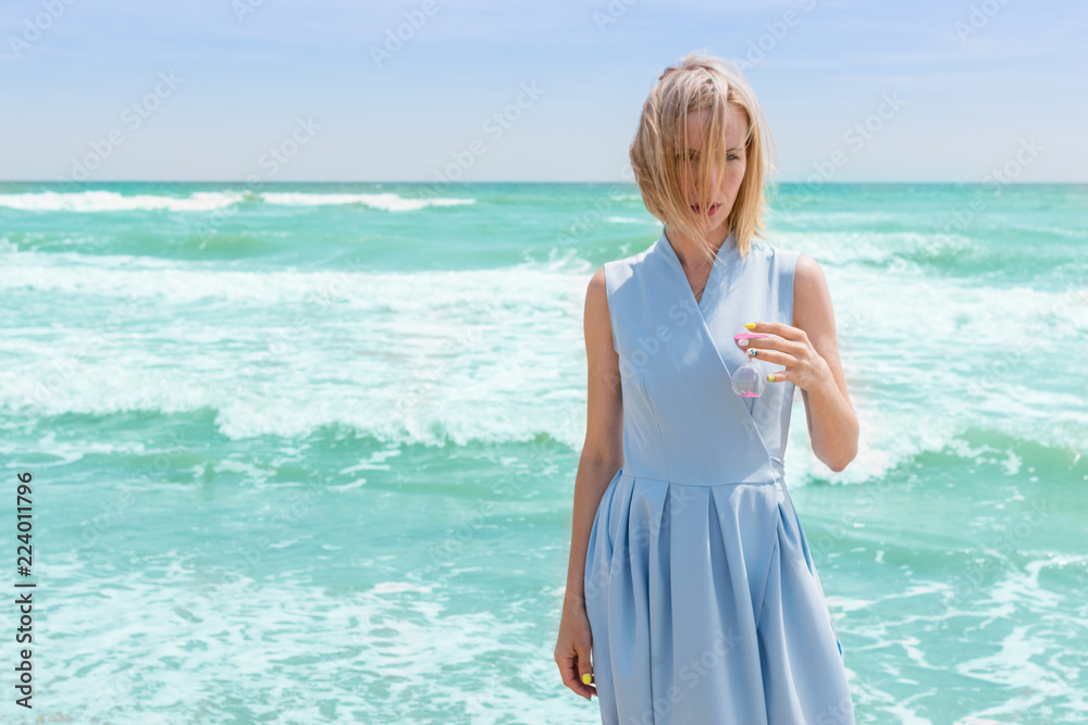 Women holding hourglass and sea background, concept travel in summer Women holding hourglass and sea background, concept travel in summer