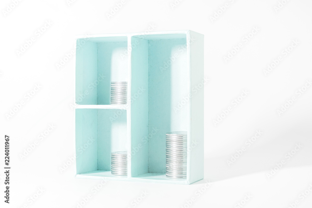 The concept of money, investments, savings. Stack of coins in a closet on a white background. The concept of money, investments, savings. Stack of coins in a closet on a white background.