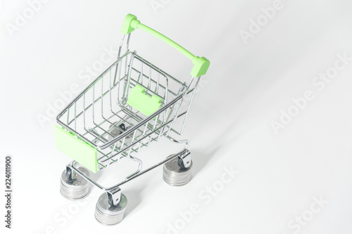 Shopping. The concept of purchases, consumer credit. Purchases on credit. Shopping trolley on coins.