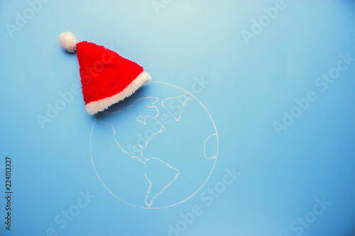 santa clous hat on the earth. merry christmas world