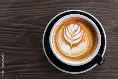 A beautiful cup of Latte art on the wooden space background. Top view, flat lay copy space for your text.