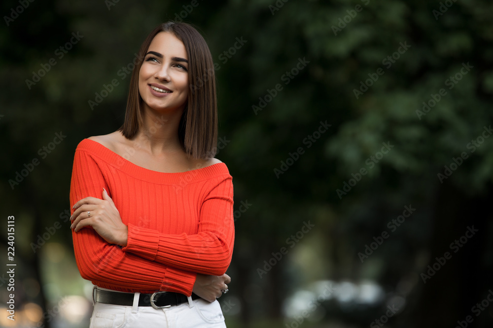 Portrait of woman in red sweater walking during cold day autumn at the park Portrait of woman in red sweater walking during cold day autumn at the park