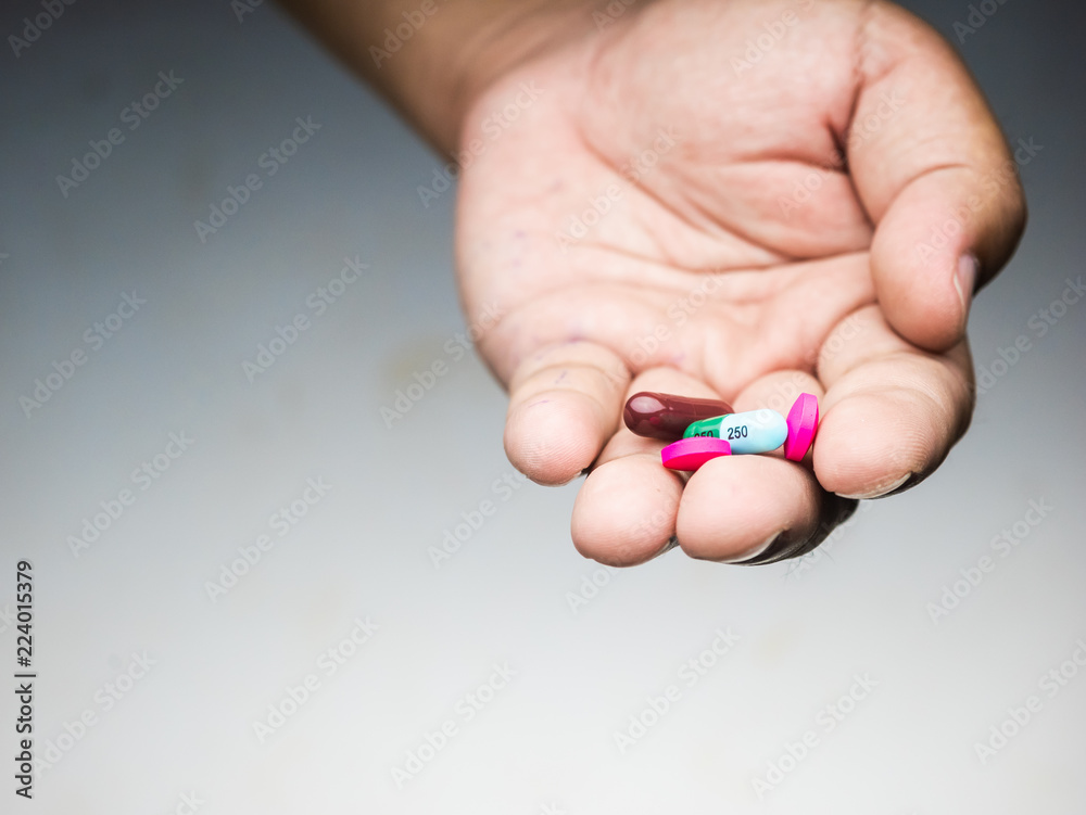 drug capsule medical in hand man wood background