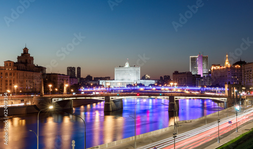 House of the government of the Russian Federation, beautiful Moscow river, night road and water traffic along the river and the embankment © miklyxa