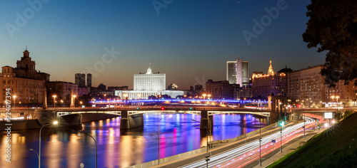 House of the government of the Russian Federation, beautiful Moscow river, night road and water traffic along the river and the embankment © miklyxa