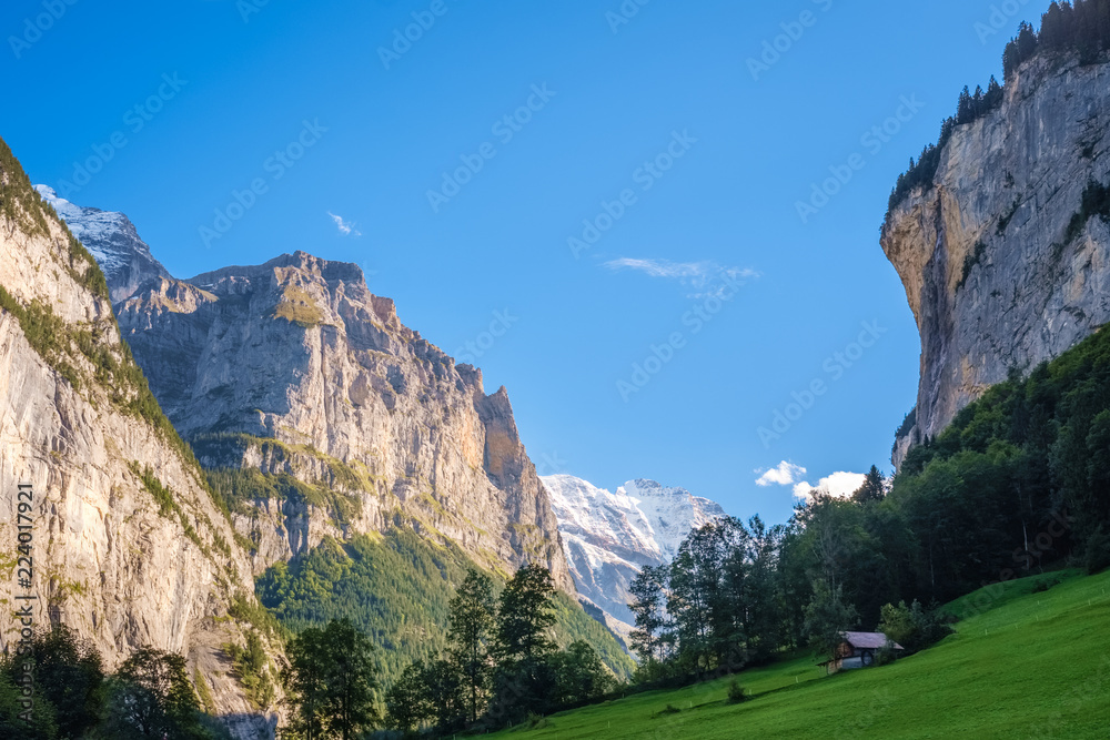 Sun is slowly beginning to set on afternoon at the Lauterbrunnen Valley (Berner Oberland, Switzerland). It lies at the bottom of the Lauterbrunnen valley. It is one of the deepest in the Alpine chain.