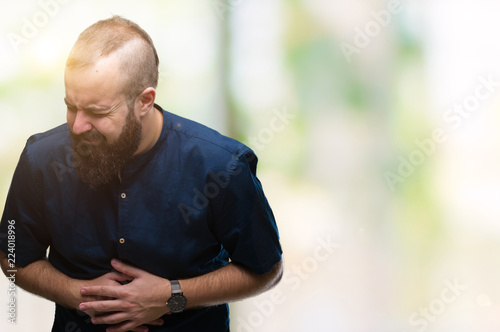 Young caucasian hipster man over isolated background with hand on stomach because nausea, painful disease feeling unwell. Ache concept.