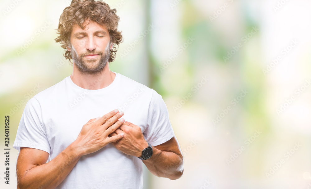 Handsome hispanic model man over isolated background smiling with hands on chest with closed eyes and grateful gesture on face. Health concept.