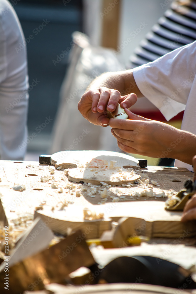 Children learn to make custom violin and other musical instruments in outdoor fablab classes. Joiner's training on makerfaire. Children learn to make custom violin and other musical instruments in outdoor fablab classes. Joiner's training on makerfaire.