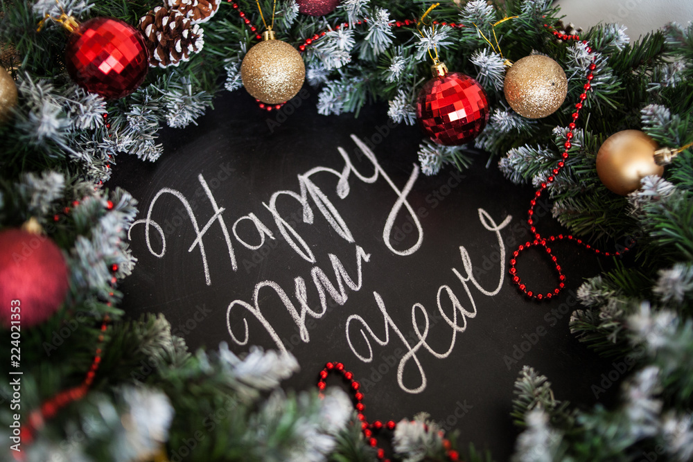 Inscription Happy New Year on black board. Black board with hand inscription Happy New Year with chalk.