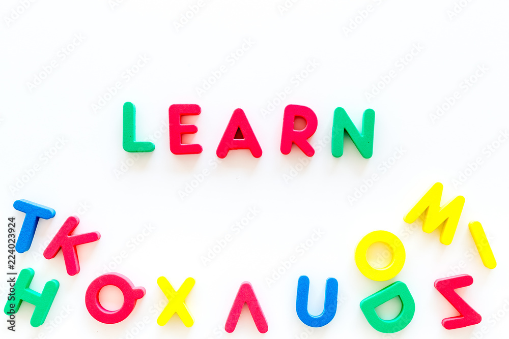 Children learn read concept. Word learn written by plastic letters on white background top view copy space