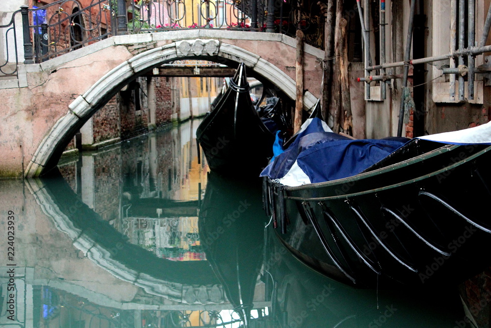 Canal in Venice. Bridge, boat and reflection