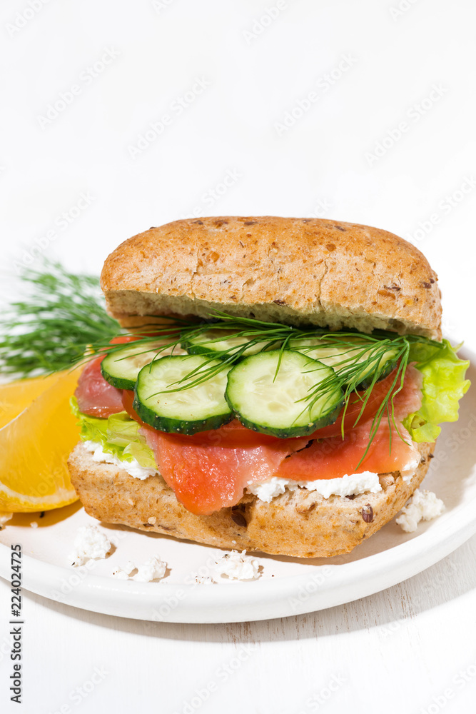 sandwich with salted fish, fresh vegetebles and cream cheese on the plate, vertical sandwich with salted fish, fresh vegetebles and cream cheese on the plate, vertical