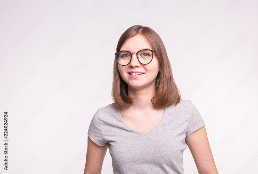 Young beautiful woman in glasses over white background with copy space