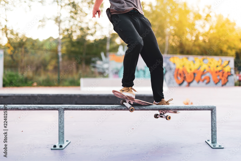 Skateboarder is doing a crooked grind trick Stock Photo | Adobe Stock