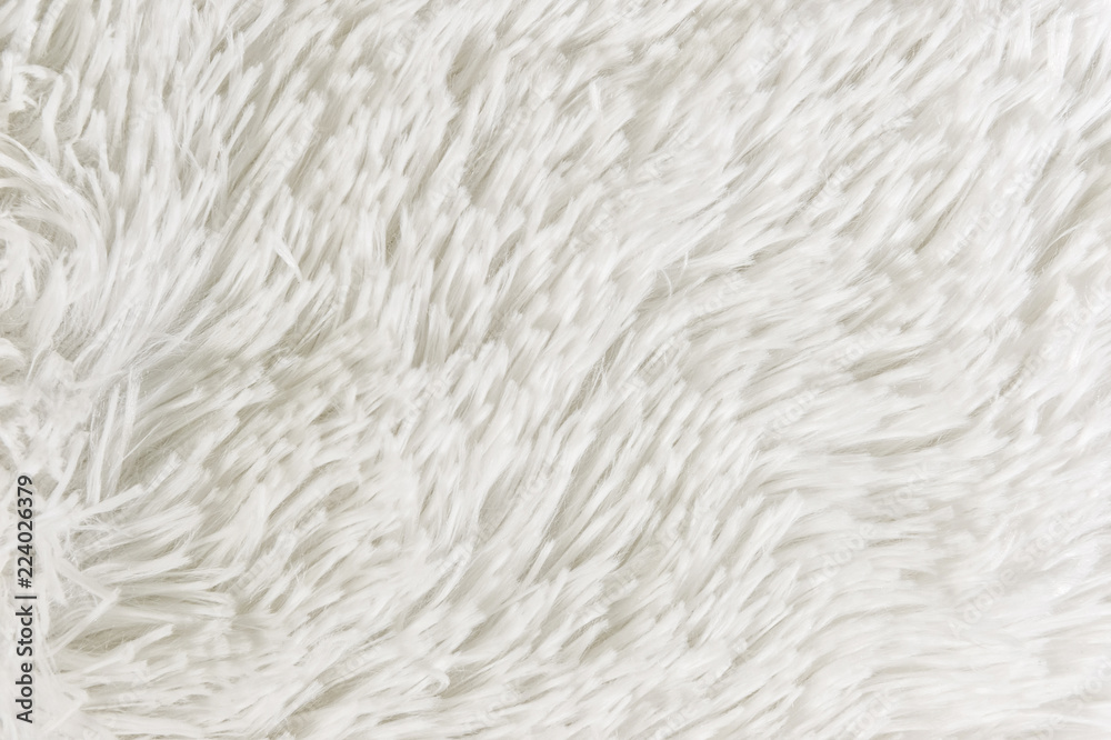 Fluffy plaid of polyester with a long heap gray. Comfortable home textiles. Background, texture