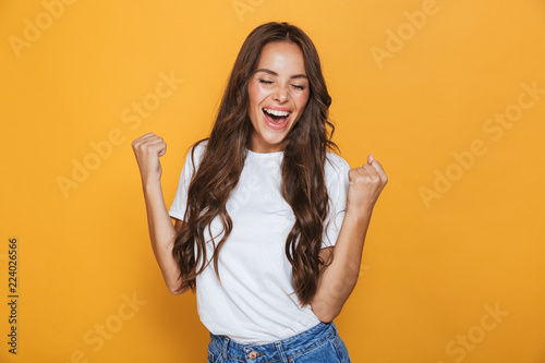 Portrait of a happy young girl with long brunette hair