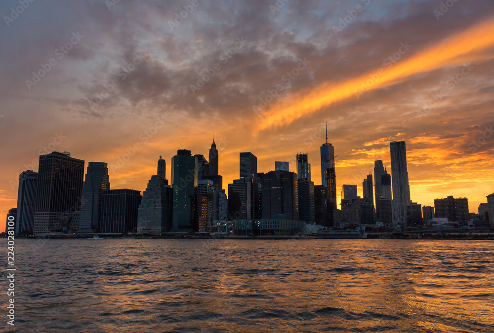 Manhattan skyline from Brooklyn under a moody sky at sunset (New York, USA)