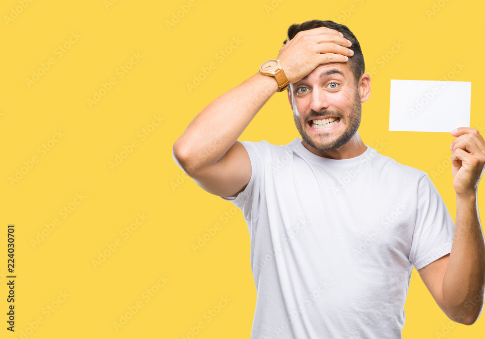 Young handsome man holding blank card over isolated background stressed with hand on head, shocked with shame and surprise face, angry and frustrated. Fear and upset for mistake. Young handsome man holding blank card over isolated background stressed with hand on head, shocked with shame and surprise face, angry and frustrated. Fear and upset for mistake.