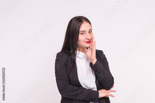 Expressions and people concept - Portrait of beautiful young asian woman with red lips dressed in black jacket smiling and thinking over white background with copy space