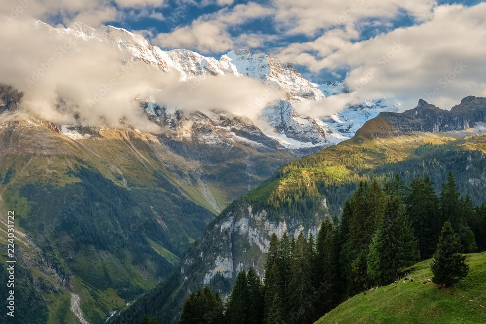 Fototapeta premium The sun is setting on the gorgeous mountains near the town of Murren (Berner Oberland, Switzerland). Murren is a traditional mountain village and is unreachable by public road.
