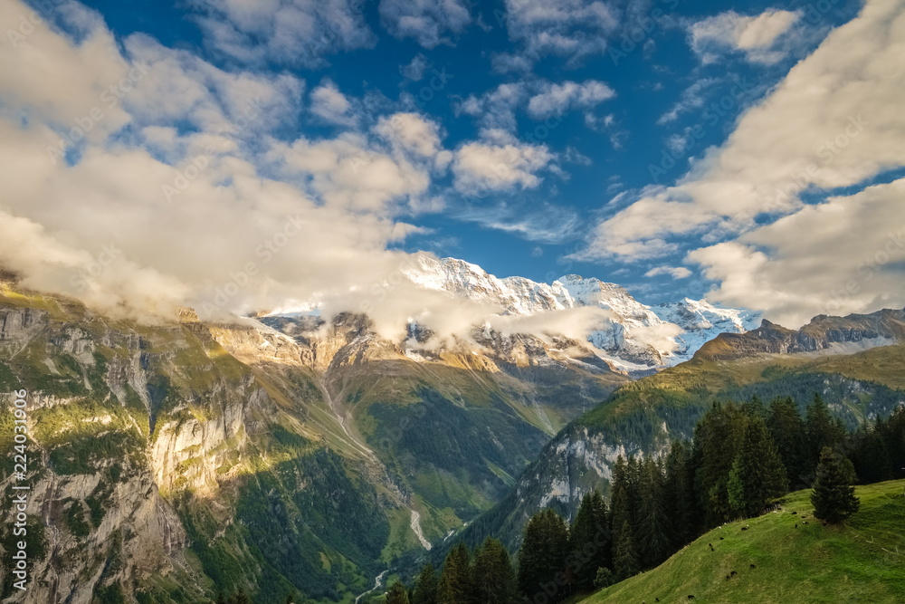 The sun is setting on the gorgeous mountains  near the town of Murren (Berner Oberland, Switzerland). Murren is a traditional mountain village and is unreachable by public road.