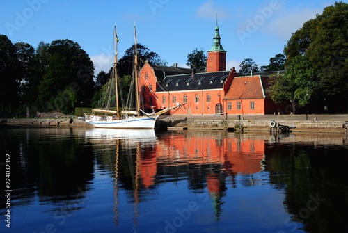 Halmstad Castle (Halmstads slott), a 17th-century castle on the Nissan river in Halmstad, in the province of Halland, Sweden with a two-master moored in front photo