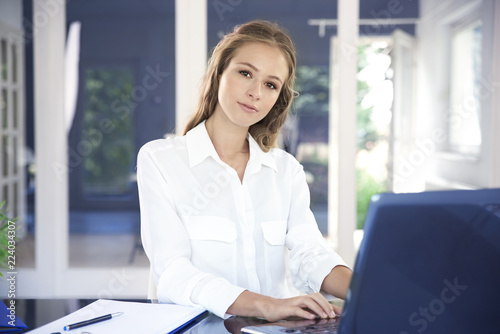 Businesswoman typing on laptop in the office