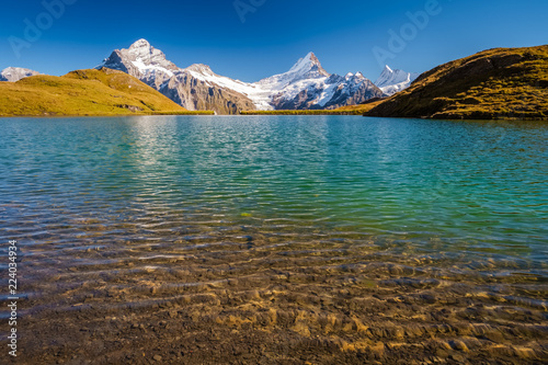 Encountering Bachalpsee during the famous hiking trail from First to Grindelwald (Bernese Alps, Switzerland). You can have great views on mountains like the Eiger, Monch and Jungfrau.