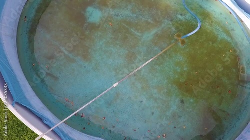 Overhead view of a half empty swimming pool needs to be cleaned