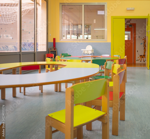 Interior view of diner with colorful tables and chairs in kindergarten. Kindergarten concept