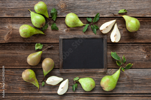 Fresh ripe pears on the table. Top view, close-up on vintage wooden background, space for text